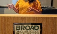 Shayla is speaking to a live audience of leaders, educating them on leading multicultural women